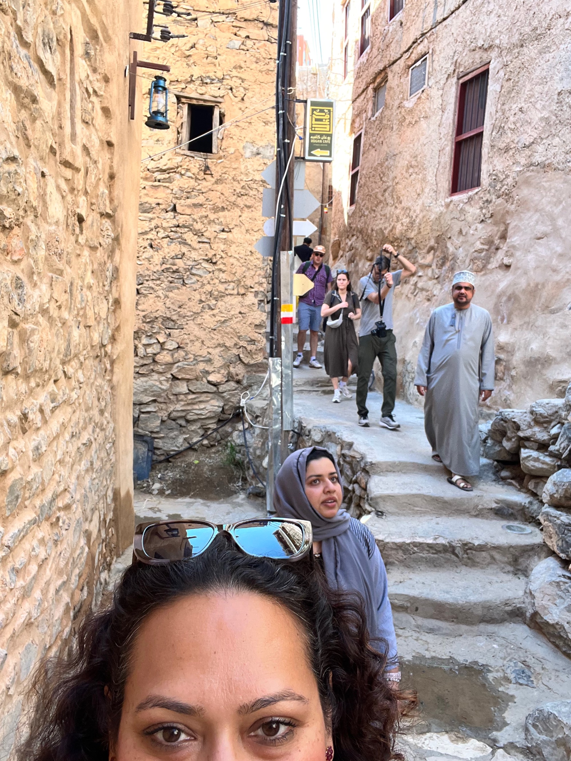 Photo of people in an alleyway in an old city